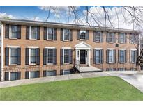 Brick exterior of a multi-story home featuring black shutters and a well-manicured lawn at 1101 Collier Nw Rd # U2, Atlanta, GA 30318