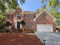 Lovely two-story brick home with a well-maintained yard and attached two car garage at 7435 Woodruff Way, Stone Mountain, GA 30087