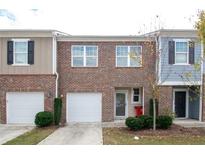 Charming brick townhome with an attached one-car garage and well-maintained landscaping at 1837 Millstream Holw, Conyers, GA 30012
