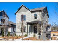 Charming two-story home with gray siding, a welcoming front porch, and a well-manicured lawn at 3322 Springhaven Ave, Hapeville, GA 30354