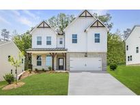 Inviting two-story home showcasing a modern farmhouse design with a pristine lawn and elegant architectural details at 5109 Hillside Haven Dr, Powder Springs, GA 30127