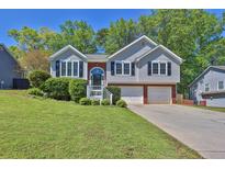 Charming two-story home features a well-maintained lawn and attached two car garage at 2865 Maple Vista Ln, Lawrenceville, GA 30044