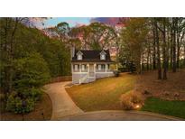 Charming home with a welcoming front porch and well-maintained lawn and driveway at 530 S Lost Lake Cv, Villa Rica, GA 30180