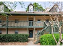 Inviting two-story apartment exterior featuring a cozy entrance and well-maintained green surroundings at 310 Brittany Ct, Duluth, GA 30096
