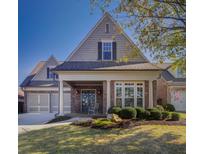 Charming brick home with a manicured lawn and inviting front porch at 314 Lakeside Trce, Canton, GA 30115