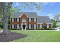 Charming two-story brick home with black shutters and a well-manicured front yard, perfect for curb appeal at 4950 Willow Creek Dr, Woodstock, GA 30188