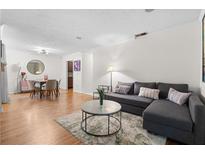 Open-concept living room with wood floors, modern furniture, and neutral decor, perfect for relaxing and entertaining at 1150 Collier Nw Rd # A7, Atlanta, GA 30318