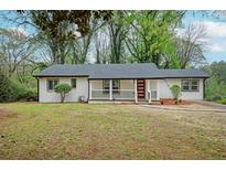 Charming single-story home with a freshly painted exterior, manicured lawn, and inviting front porch at 2190 Highview Rd, Atlanta, GA 30311