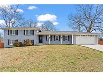 Charming single-story home with blue painted brick and a well-manicured front lawn at 2984 Bayard St, East Point, GA 30344