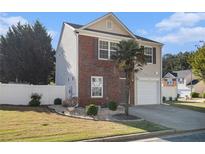 Charming two-story home featuring a brick facade, well-manicured lawn, and a quaint garden at 206 Oak Grove Way, Acworth, GA 30102