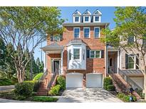 Beautiful brick townhouse with two-car garage, well-manicured landscaping and welcoming front entrance at 5888 Riverstone Cir # 15, Atlanta, GA 30339