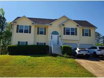 Inviting two-story home with a well-manicured front lawn and attached two-car garage at 204 Millpond Pkwy, Villa Rica, GA 30180