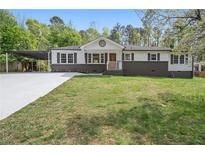 Charming single-story home with fresh exterior paint, well-kept lawn, and updated driveway at 2125 Perkerson Mill Rd, Austell, GA 30106