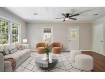 Bright living room featuring neutral tones, hardwood floors, lots of natural light and a modern ceiling fan at 2125 Perkerson Mill Rd, Austell, GA 30106