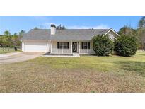 Charming single-story home featuring a welcoming front porch, attached garage, and well-maintained landscaping at 173 Michael Ln, Mcdonough, GA 30252