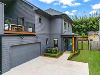 Stunning modern home with gray siding, a balcony, attached garage, and manicured landscaping at 60 Walthall Ne St # B, Atlanta, GA 30307