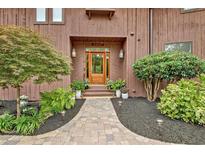 Charming front entrance with wood door, brick walkway, and beautiful landscaping at 5 Northlake Cir # 4 & 5, Peachtree City, GA 30269