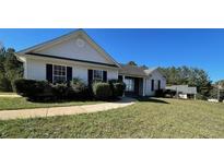 Well-maintained single-story home with a manicured lawn and mature landscaping at 40 Autumn Ct, Covington, GA 30016