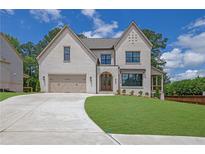 Beautiful two-story home with brick facade, well-manicured lawn, and attached two-car garage at 380 Hillcrest View Dr, Suwanee, GA 30024