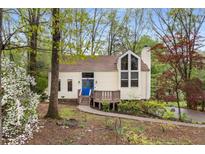Charming single-Gathering home with a blue front door, surrounded by lush trees and landscaping at 3450 Brookhill Cir, Marietta, GA 30062