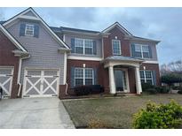 Charming two-story home with brick and gray siding, updated garage door, shutters and covered front entry at 8908 Brandy Rose, Douglasville, GA 30134