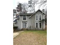 Charming two-story home with gray siding, black trim, and a well-maintained front lawn in a desirable neighborhood at 980 Fox Chase Ln, Riverdale, GA 30296