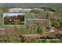 Expansive aerial view of property with generous acreage, mature trees, and pond at 896 Winn Rd, Douglasville, GA 30134