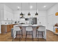 Bright modern kitchen featuring a central island with barstool seating and stainless steel appliances at 112 Rogers Ne St # 207, Atlanta, GA 30317