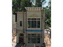 New construction home featuring multi-pane windows, architectural details, and scaffolding at 11863 Serenbe Ln, Chattahoochee Hills, GA 30268