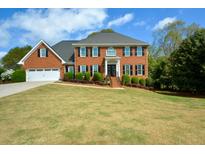 Beautiful two-story brick home with a well-manicured lawn and attached two car garage at 4455 Sirrocco Sw Ln, Lilburn, GA 30047