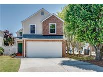 Charming two-story home with a brick and vinyl exterior, a well-manicured lawn, and an attached two-car garage at 2742 Albion Farm Way, Duluth, GA 30097