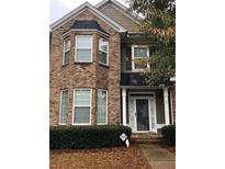Charming brick two-story home featuring manicured landscaping and inviting front porch at 5449 Festival Ave, Fairburn, GA 30213