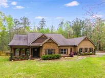 Charming single-story home with a stone facade and well-manicured lawn at 575 W Wayside Rd, Carrollton, GA 30116
