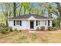 Charming single-story home with a brick facade, black shutters, and well-maintained landscaping at 2168 Doris Dr, Decatur, GA 30034