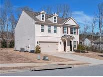 Charming two-story home with gray siding, brick accents and a two-car garage at 5460 Wheeler Ridge Rd, Auburn, GA 30011