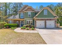 Charming two-story home featuring a two-car garage, stone accents, manicured landscaping and a walkway to the front door at 116 Edgeview Ct, Dallas, GA 30157