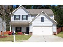 Charming two-story home featuring a well-manicured lawn and attached two-car garage, enhancing curb appeal at 20 Autumn Canyon Se Path, Cartersville, GA 30121