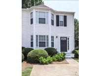 Charming townhouse featuring a well-maintained lawn, beautiful landscaping, and a welcoming front entrance at 4420 Thorngate Ln, Acworth, GA 30101