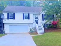 Charming split-level home featuring a two-car garage, classic white siding, and well-maintained landscaping at 4443 Whitt Mill Nw Rd, Acworth, GA 30101