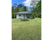 Charming single-story home featuring a well-manicured lawn and a welcoming front porch swing at 3127 Bright Star Rd, Douglasville, GA 30135