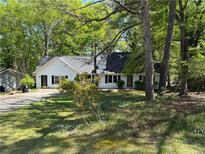 Charming single-story home with mature trees and a well-maintained lawn, offering great curb appeal at 3013 Barcelona Way, Conyers, GA 30012