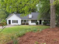 Charming one-story home with white siding, black shutters, and a well-manicured lawn at 3013 Barcelona Way, Conyers, GA 30012