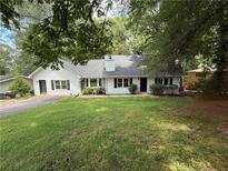 Charming single-story home with a well-maintained lawn and mature trees at 3013 Barcelona Way, Conyers, GA 30012