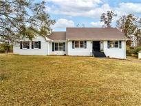 Charming single-story home with a brick exterior, dark shutters, and a well-manicured lawn at 1828 Kellogg Creek Rd, Acworth, GA 30102