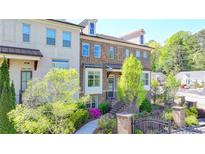 Beautiful brick townhome featuring manicured landscaping, brick stairs, and a charming front entrance at 4007 Dunwoody Trce, Atlanta, GA 30338