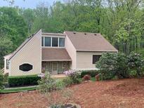 Charming two-story home featuring manicured landscaping and unique architectural details nestled among mature trees at 4487 Park Place Ter, Marietta, GA 30066