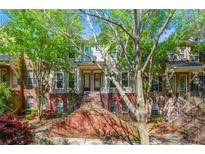 Charming two-story townhouse with a brick staircase and manicured landscaping, creating an inviting curb appeal at 1647 Sabastian Ne Pt, Atlanta, GA 30329
