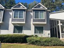 Attractive two-story townhome featuring bay windows, neutral siding, and mature landscaping at 25 Fair Haven Way, Smyrna, GA 30080