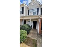 Traditional-style home featuring vinyl siding and manicured shrubbery around the front entrance at 930 Parkway Rd, Union City, GA 30291