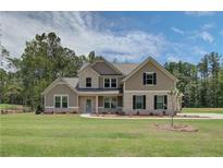 Inviting two-story home featuring manicured landscaping and a charming light blue front door at 21 Homesite Cooper E Cv, Fayetteville, GA 30215